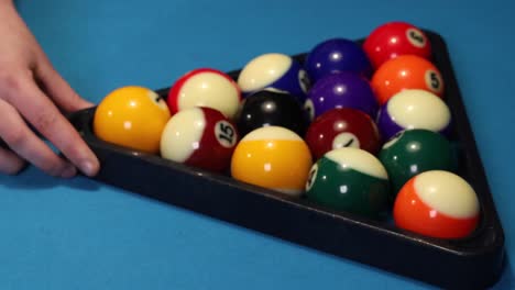 close up shot of setting up the rack for the start shot of a game of pool billiards