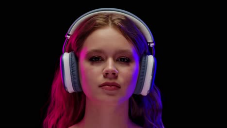 young woman with headphones expressing emotions in neon light