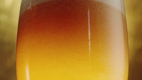 close up of a glass of beer with foam