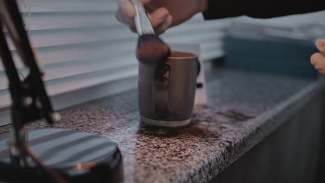 cleaning a mug with a brush