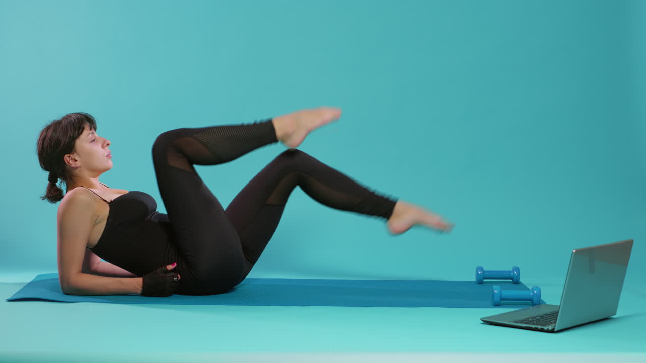 Fit woman training legs muscles with bicycle exercise