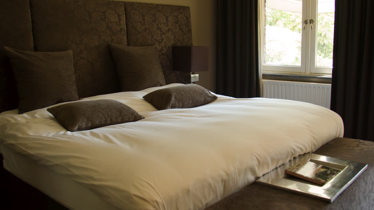 Dolly of beautiful double bed in hotel room
