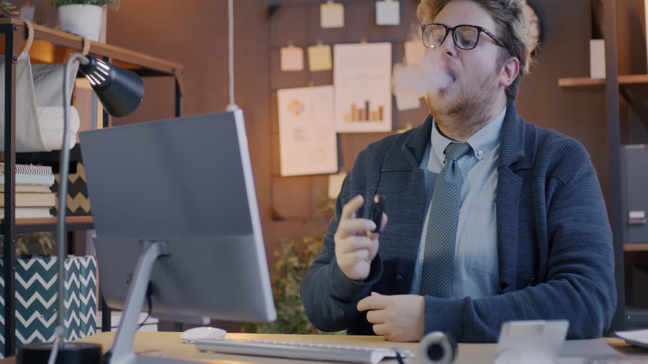 Businessman Vaping at His Desk
