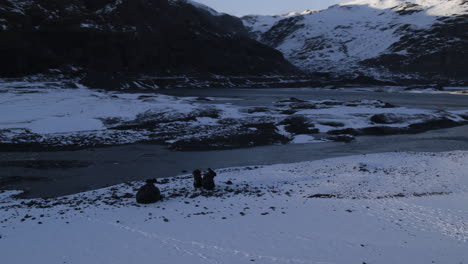 aerial rotating shot of parachuters packing their chutes in a mountain valley in iceland