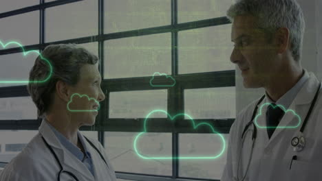 animation of cloud icons over caucasian male and female doctor in discussion