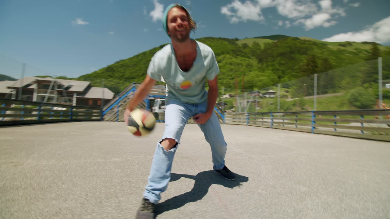 A man is dribbling a basketball on an outdoor court