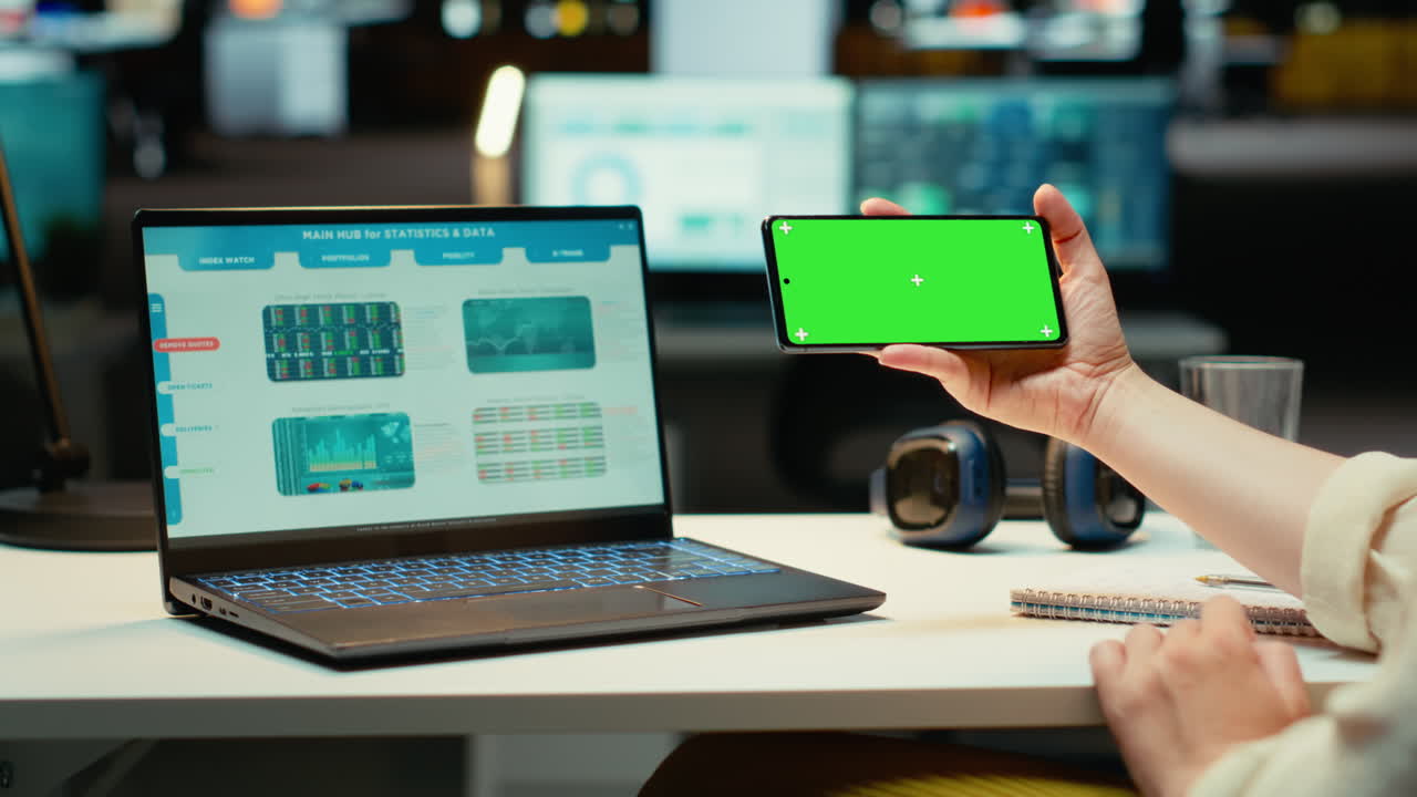Vertical Video Businesswoman looking at green screen on mobile phone during work session