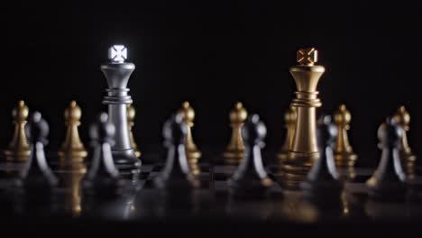 from darkness chess board is lit up revealing two rival kings squaring off