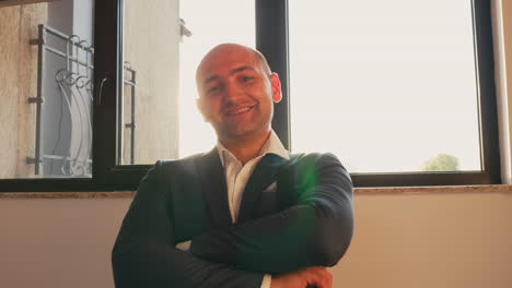 Businessman-looking-at-camera-standing-on-stairs