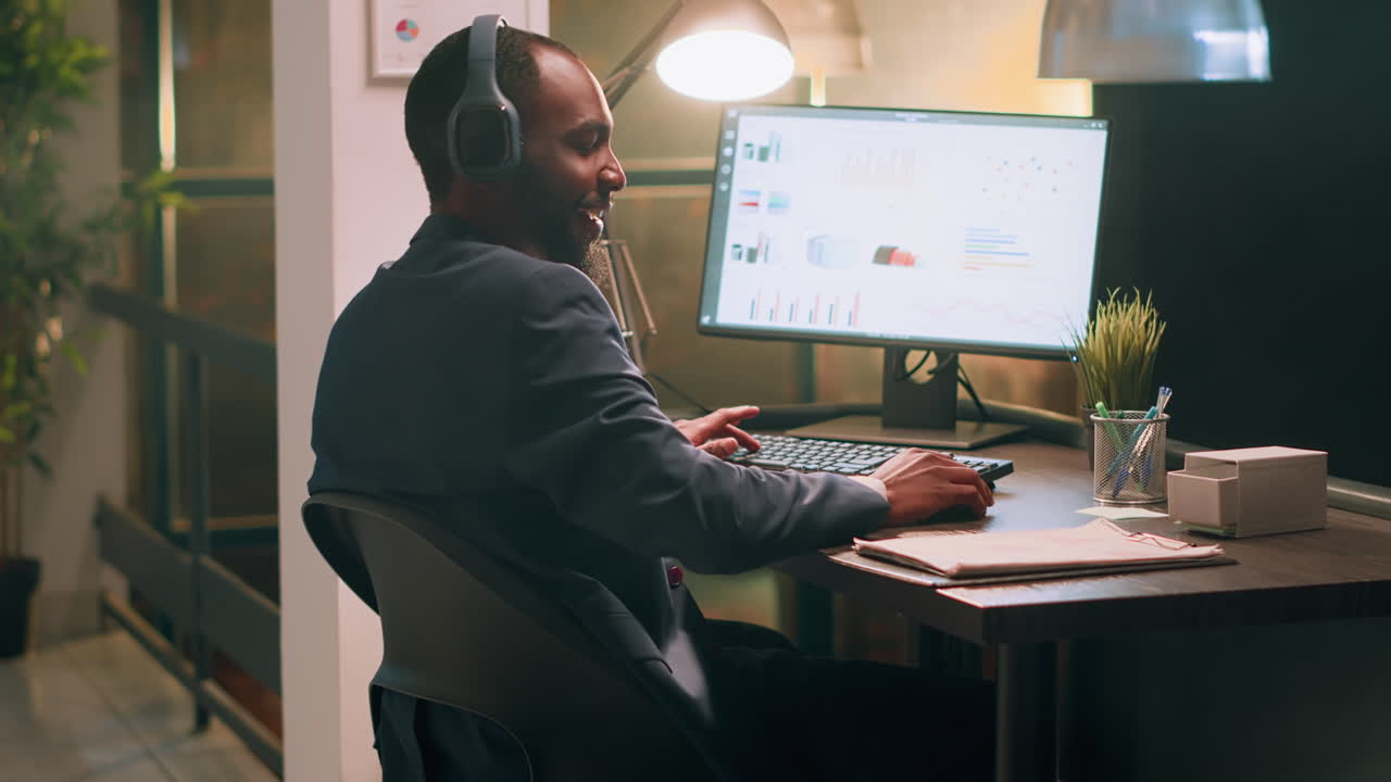 Man working at a computer with headphones