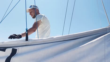 sailor working on a sailboat