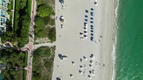 beach line with classic looking umbrellas and bike trail