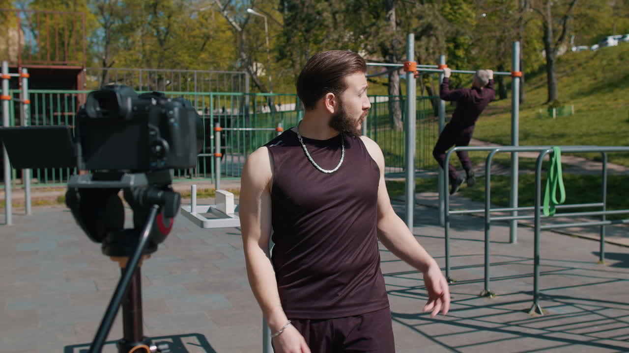 Athletic bodybuilder man records video lessons talking to camera selfie blog vlog for social media