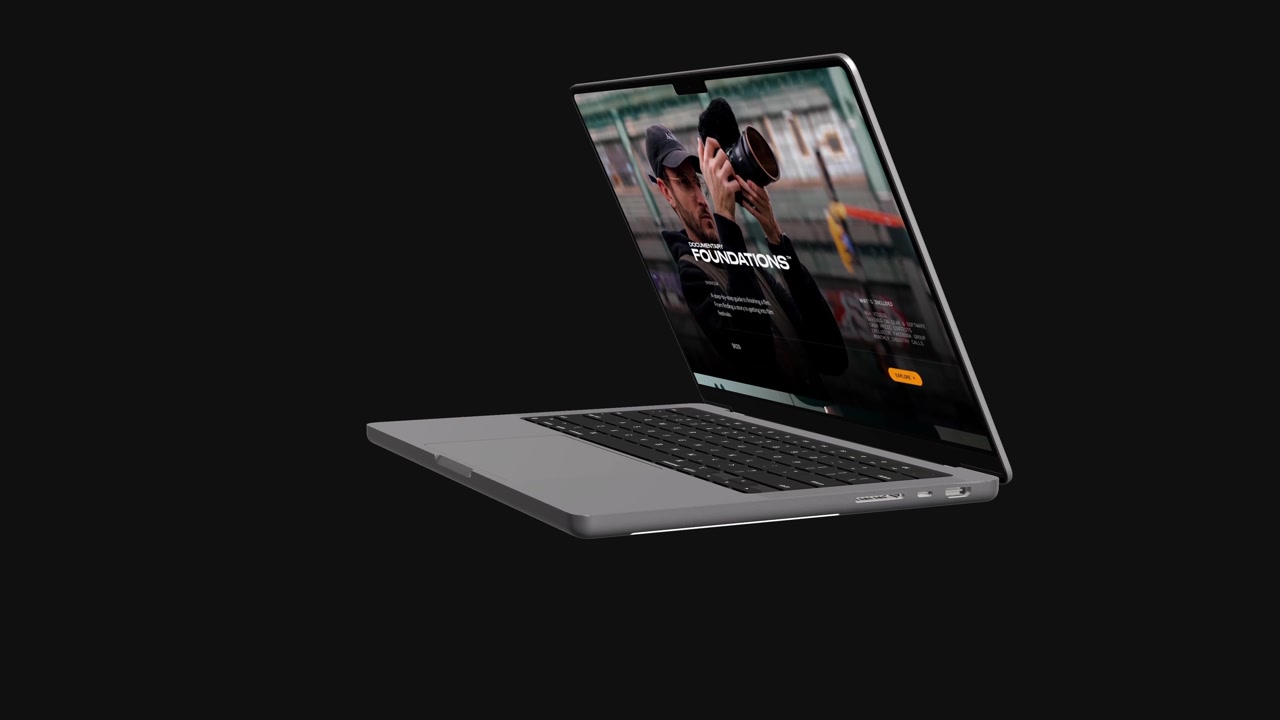 Elegant laptop åbner og viser en hjemmeside på en sort baggrund.