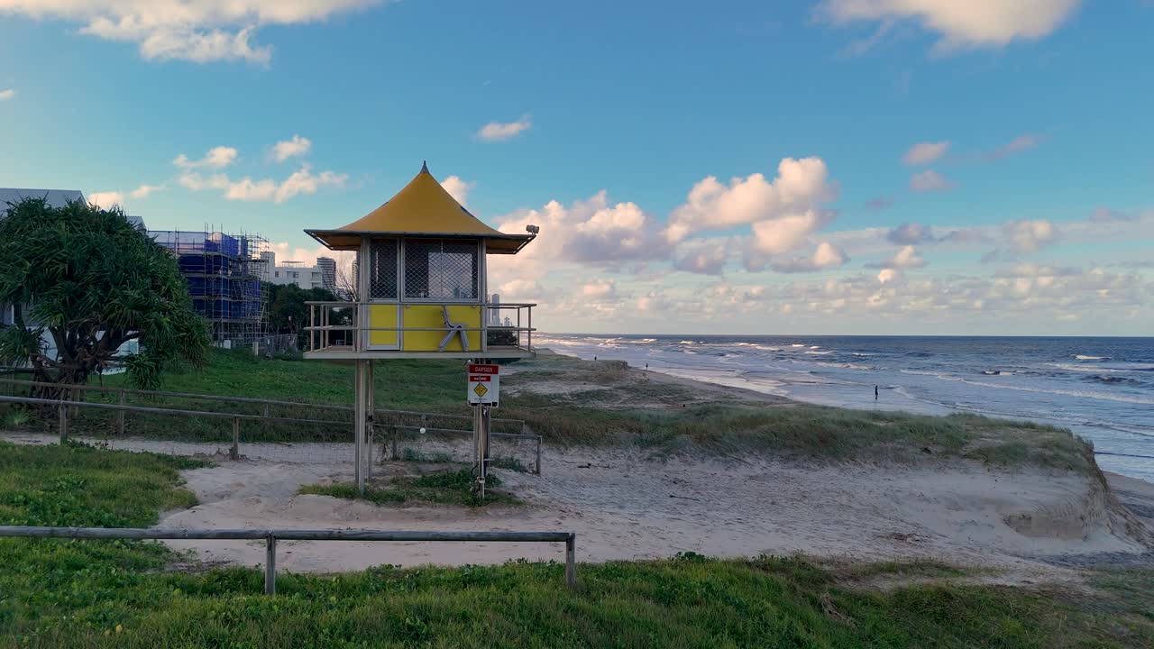 Aerial view of a lifeguard tower on Gold Coast beach. Captures serene coastal landscape with vibrant skies and gentle waves