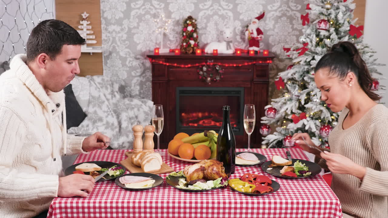 Couple Celebrating Christmas with Dinner and Champagne Toast