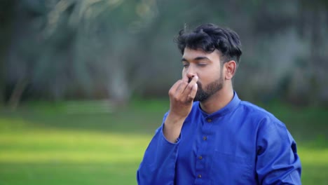 indian man doing breathing yoga exercise