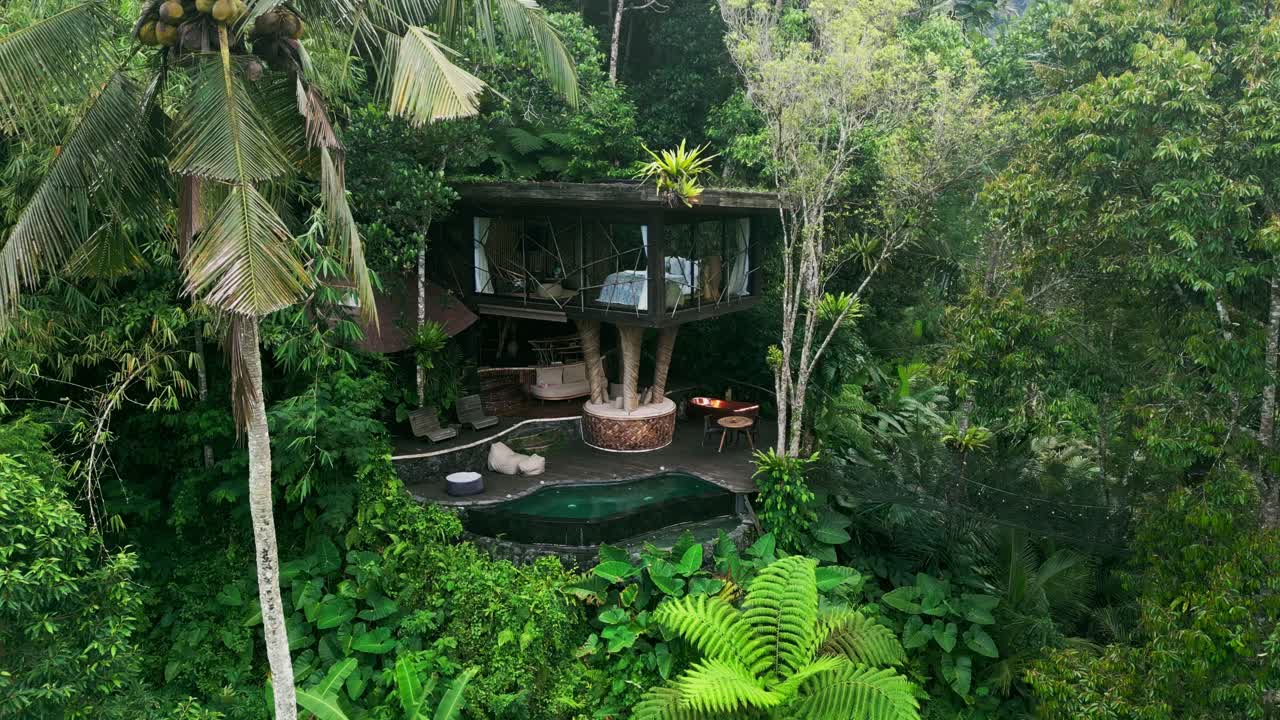 Aerial video shows a handcrafted eco villa in Bali built among forest trees. With organic bamboo textures, open design, and a tranquil pool, it captures the spirit of tropical living