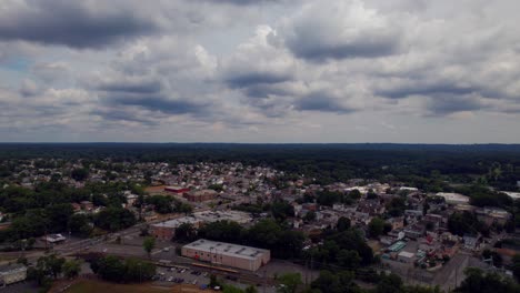 A-high-angle,-aerial-drone-shot-over-the-suburban-neighborhood-of-Glen-Cove-on-Long-Island,-NY-on-a-cloudy-day