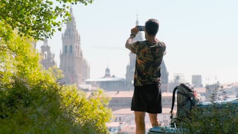 man tourist taking photo of church in santiago de compostela