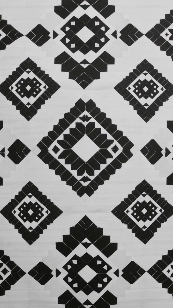 Vertical video: Panning camera after framing shift in room, showing wallpaper with diamond motifs