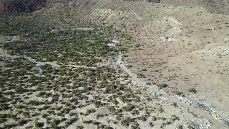 Garbage-Along-the-Roadside-in-the-Desert-Region-of-Mulege,-Baja-California-Sur,-Mexico---Aerial-Drone-Shot