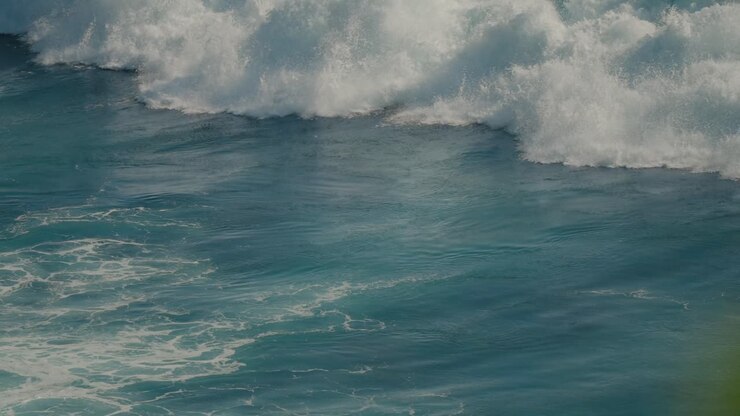Foamy white water wave crashing in super slow motion