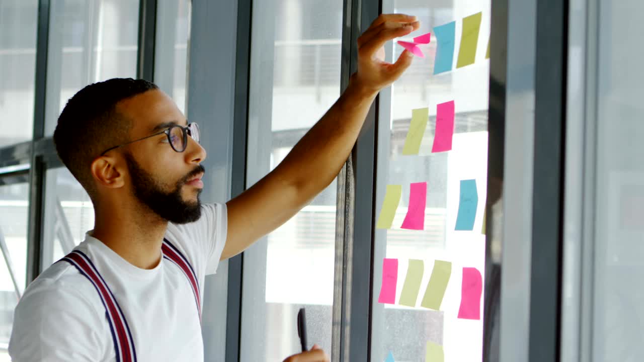 Male architect writing on sticky notes 4k