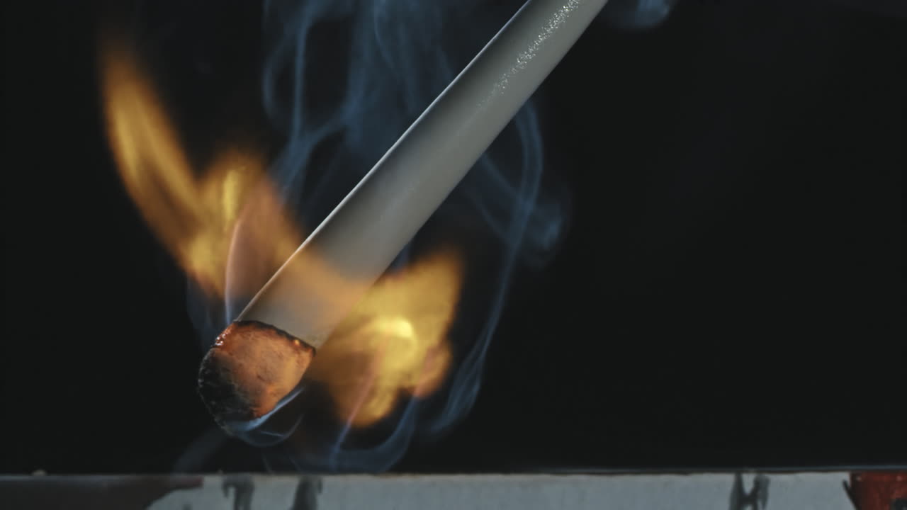 A burning match with smoke