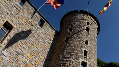 stone castle tower with flags