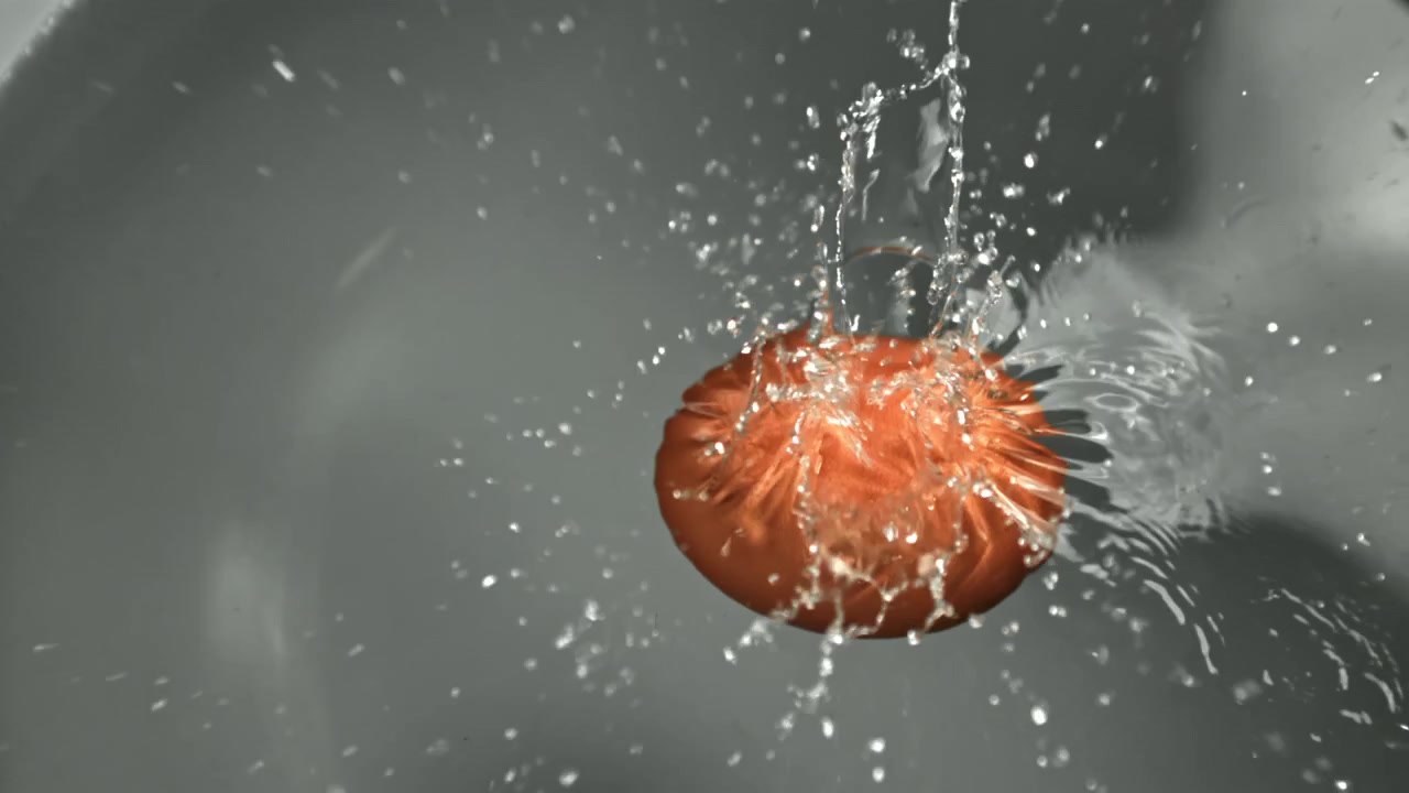 Egg Yolk Splashing into Water in Slow Motion