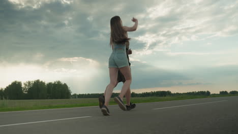 rear view of sister stretching hand to catch brother as they run along empty country road under cloudy sky, long hair flowing, golden sunlight filtering through clouds adds warm glow to playful chase