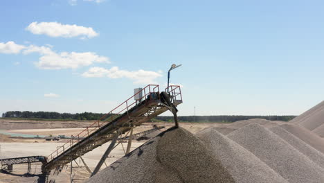 conveyor belts move the gravel into the stockpile at quarry site. - aerial shot