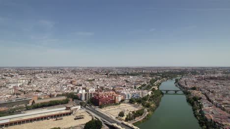 drone flying above the famous guadalquivir river in the center of seville city