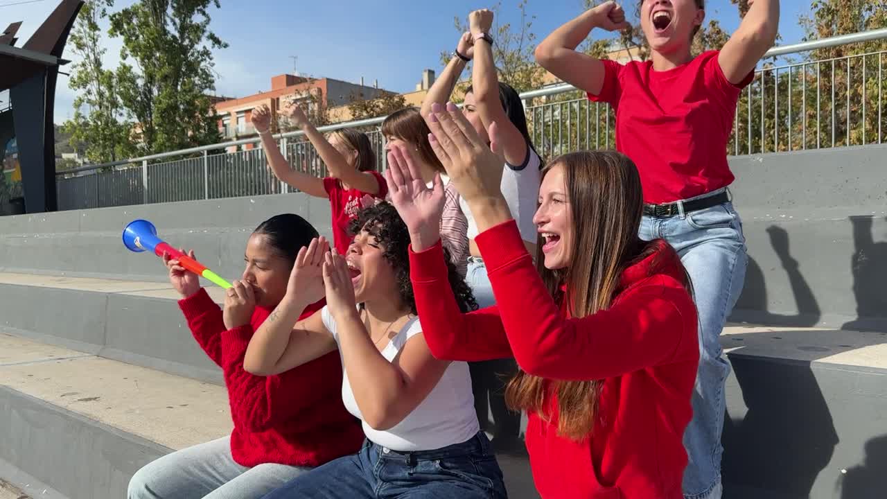 Group of women cheering in bleachers