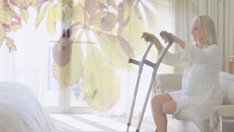 animation of tree over disabled caucasian woman using crutches