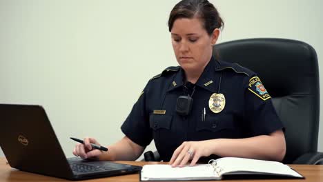 police officer working at a desk