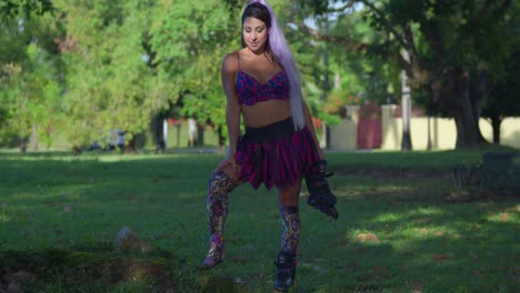 Young-amazing-woman-holds-one-of-her-roller-blades-while-at-the-park-on-a-sunny-day