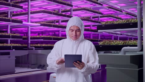 vertical farm employee working with tablet