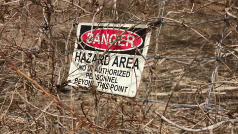 sign on fence indicates danger hazards area