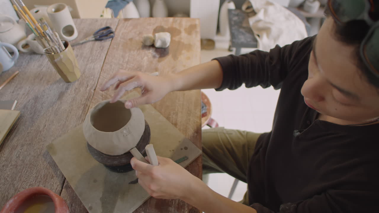 Ceramist Attaching Handle to Mug
