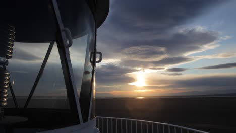 timelapse of a lighthouse lantern room at sunset