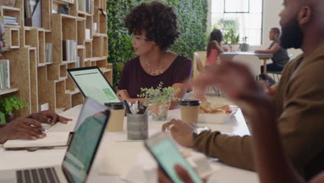 african-american-business-people-meeting-brainstorming-team-leader-woman-presenting-finance-data-using-tablet-technology-sharing-project-strategy-colleagues-working-together-in-office-boardroom