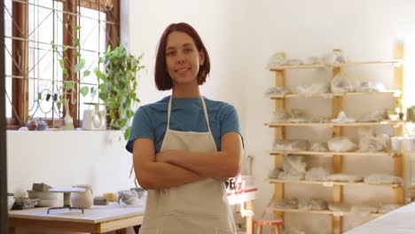 Young-female-potter-working-in-her-studio