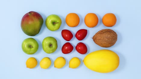 fresh ripe fruits making  vibrant  creative layout on bright blue background. stop motion flat lay