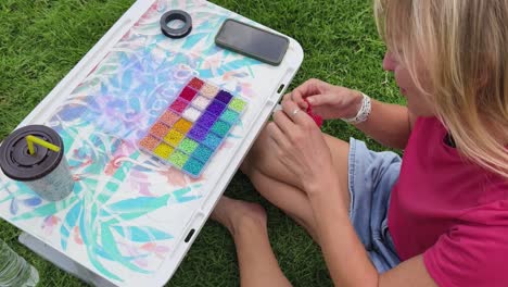 woman beading outdoors