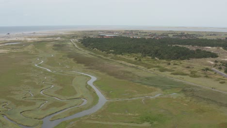 Cinematic drone - aerial shot of the green and sandy nature beach of St. Peter Ording at the north sea, schleswig holstein, germany, 30p