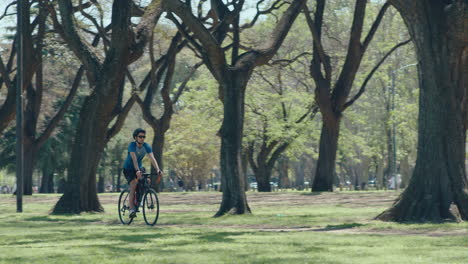 man biking in the park on a sunny weekend day
