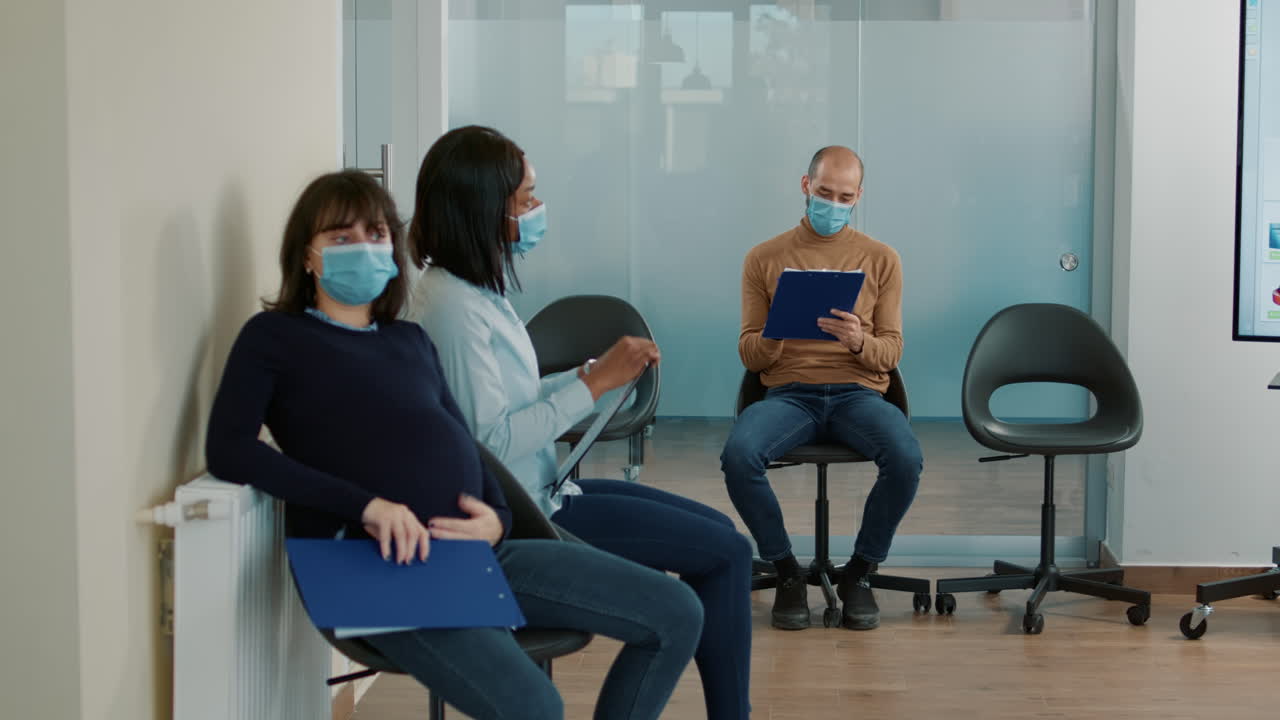 Tired applicant with pregnancy belly waiting at job interview appointment