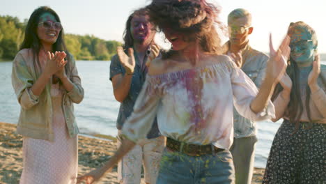 friends celebrating holi on the beach